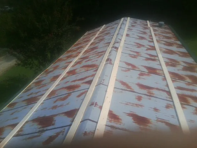 Rusted metal roof panels with new wood purlins before replacement — Storm Damage Roof Repair in Braceville by Roofing Brothers