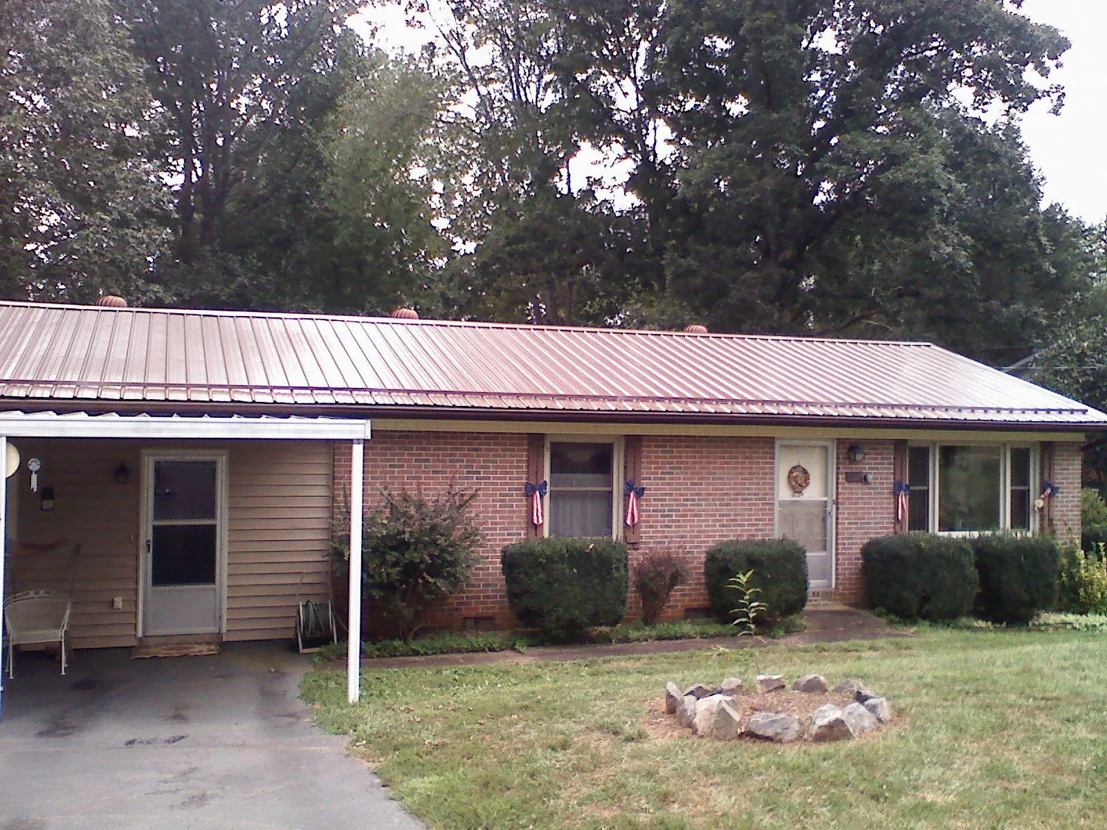 Bronze metal roof and carport on a brick ranch home — Roof Repair work by our crew in Braceville