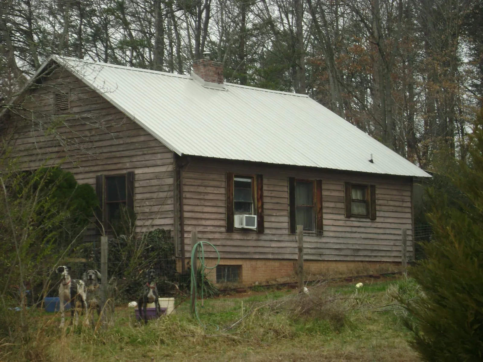 White metal roof on an old wood sided farmhouse, from a Metal Roof Installation job in Braceville
